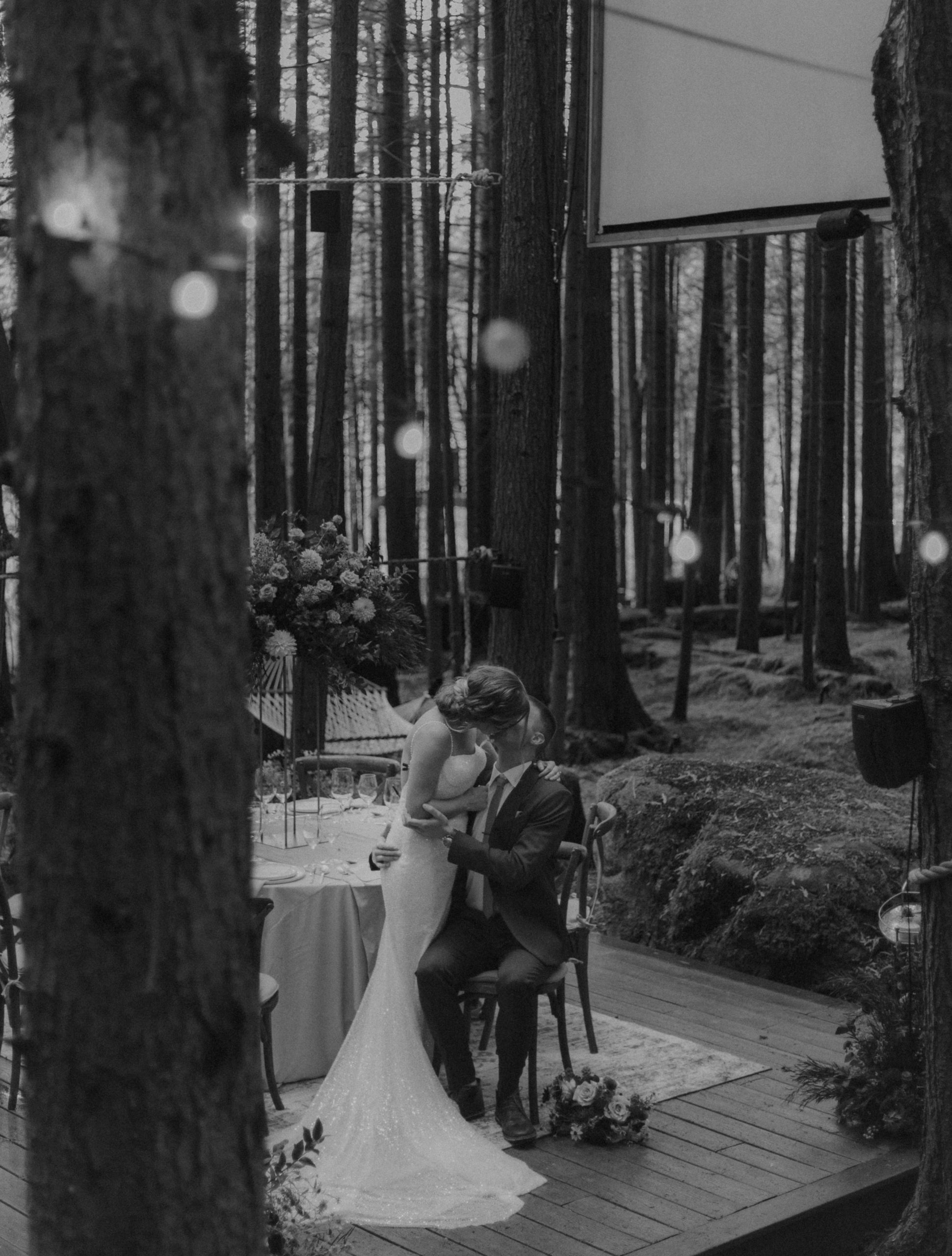 bride and groom kissing treehouse and emerald forest landscape

