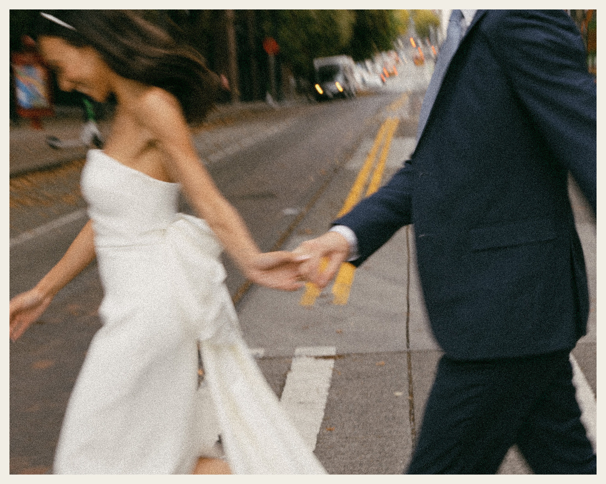 bride and groom walking across street downtown seattle