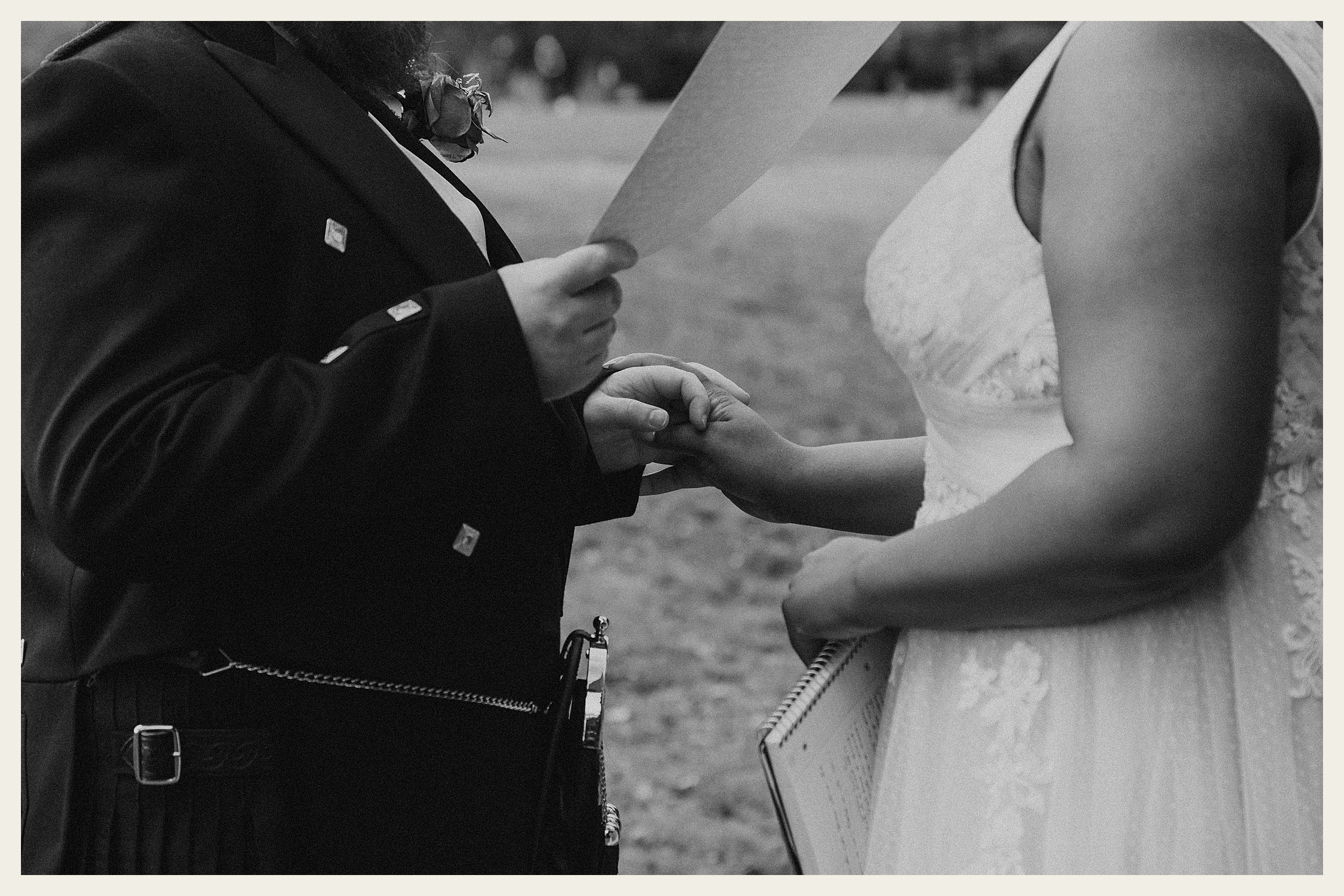 bride and groom holding vows