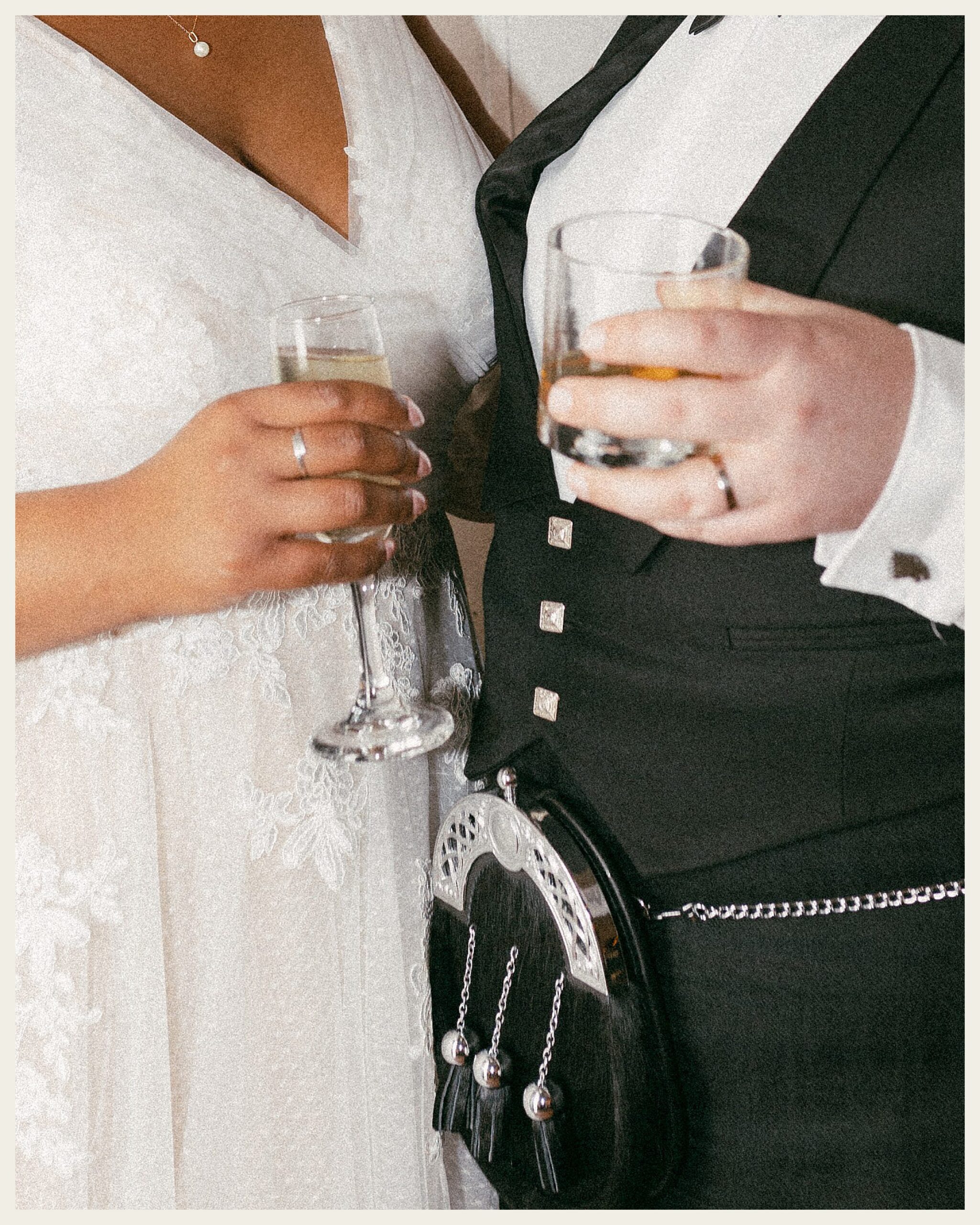 bride and groom holding drink glasses