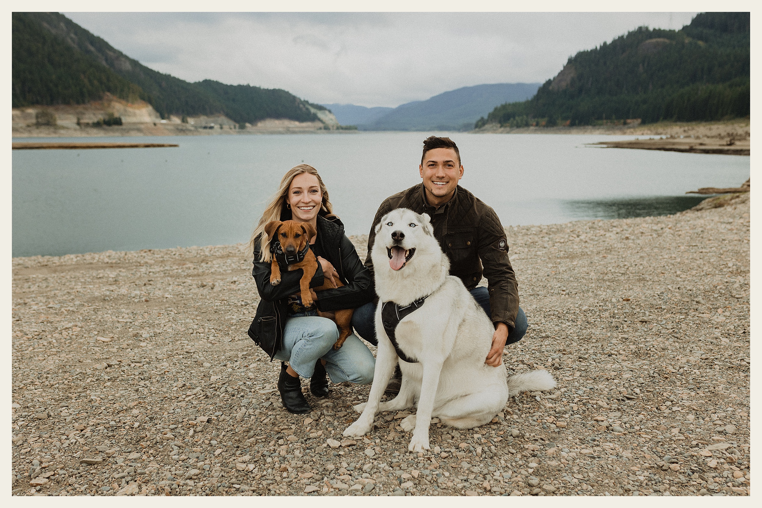 couple posing with dogs