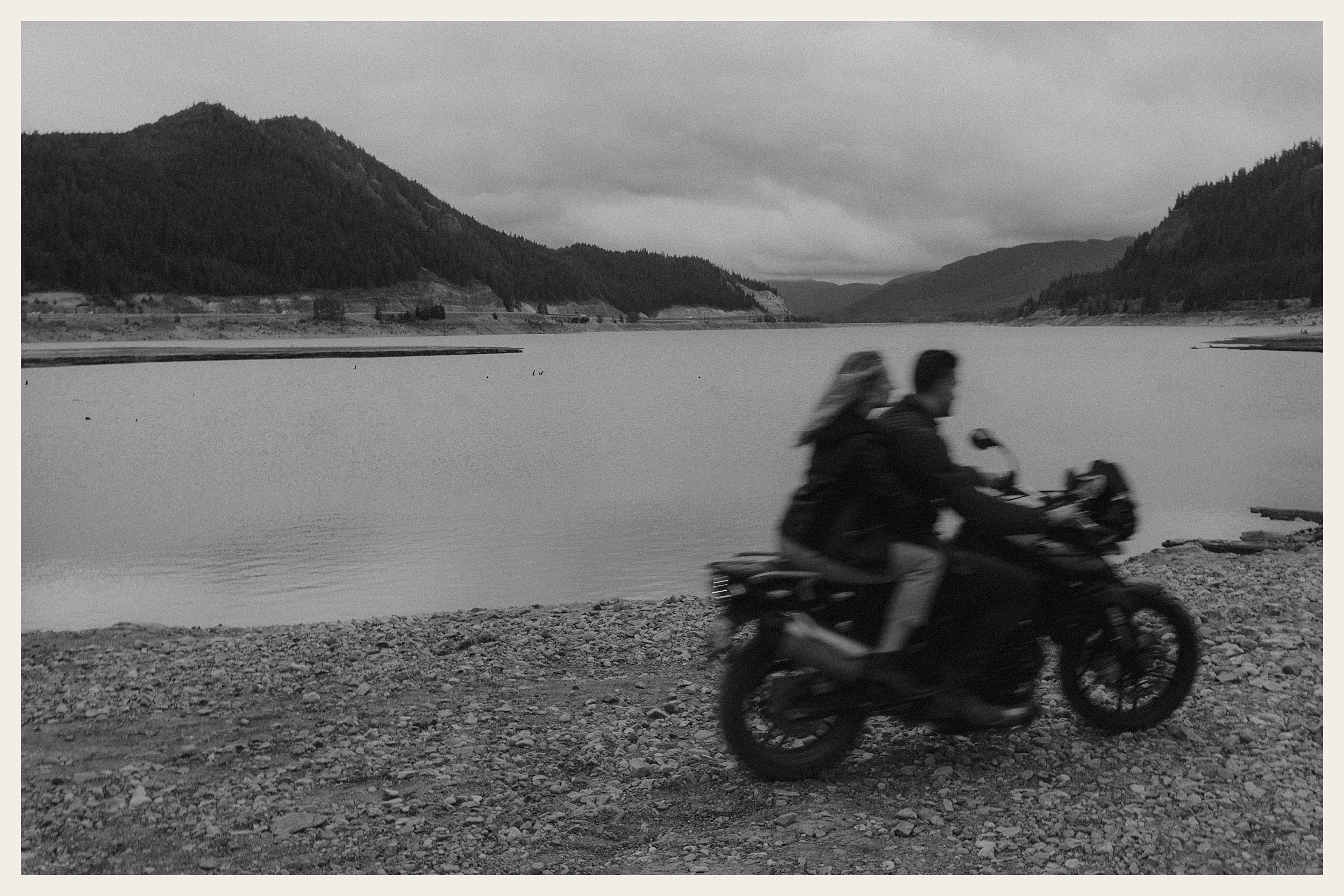 couple riding motorcycle on beach