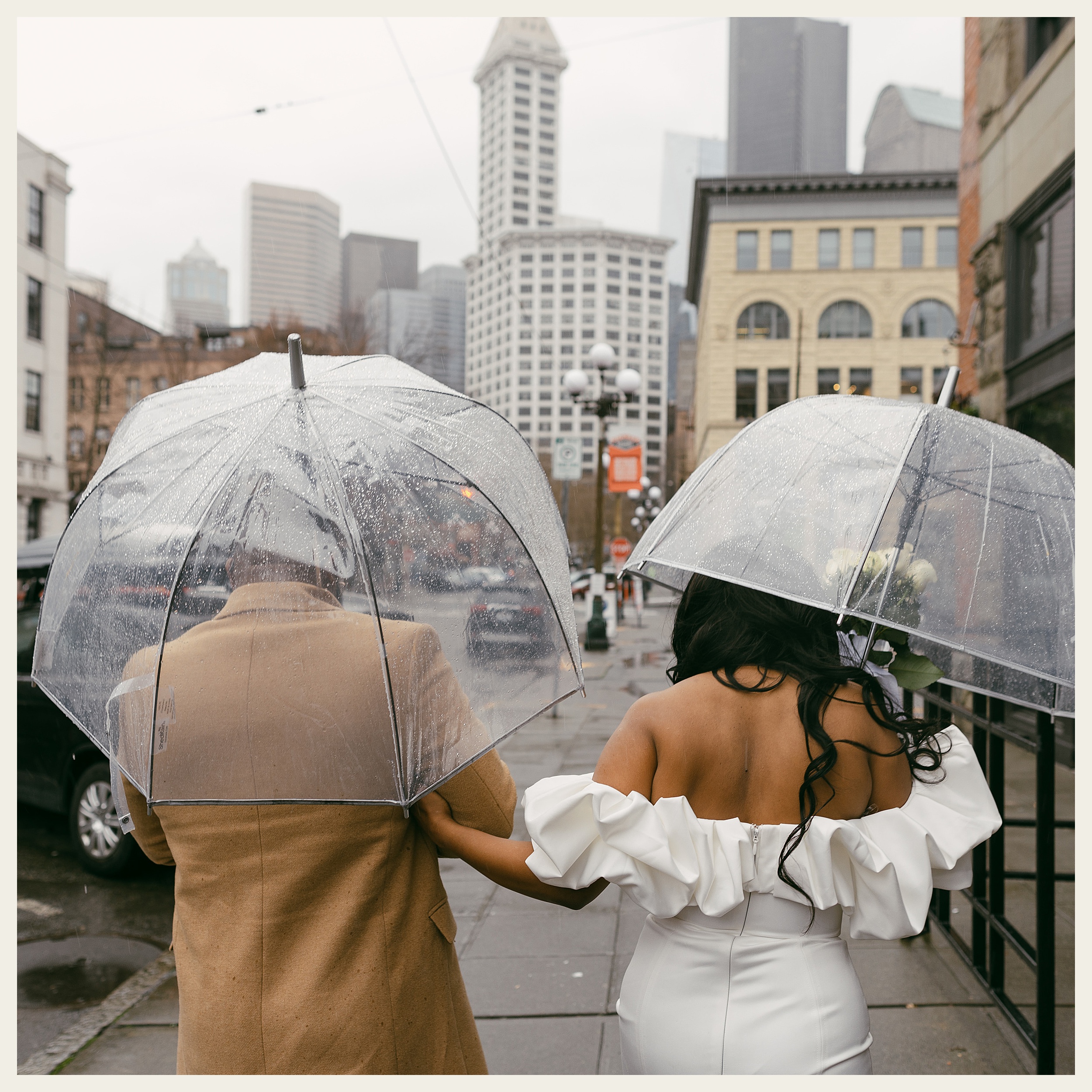 bride and groom under umbrellas