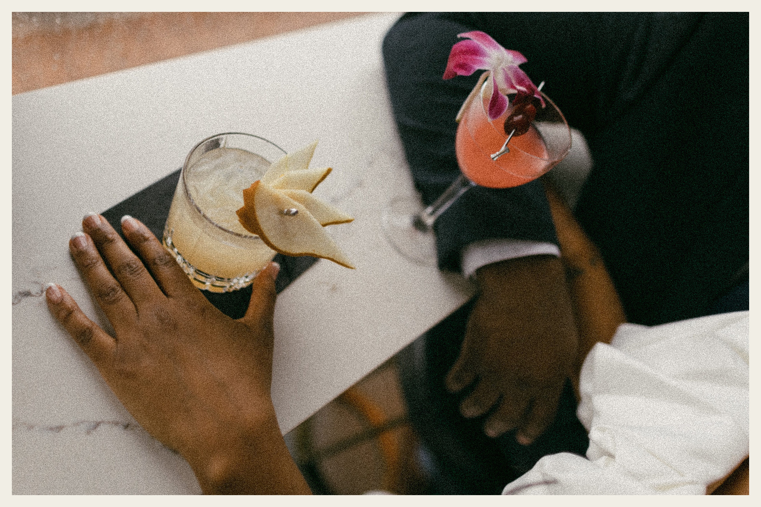 bride and groom holding cocktails