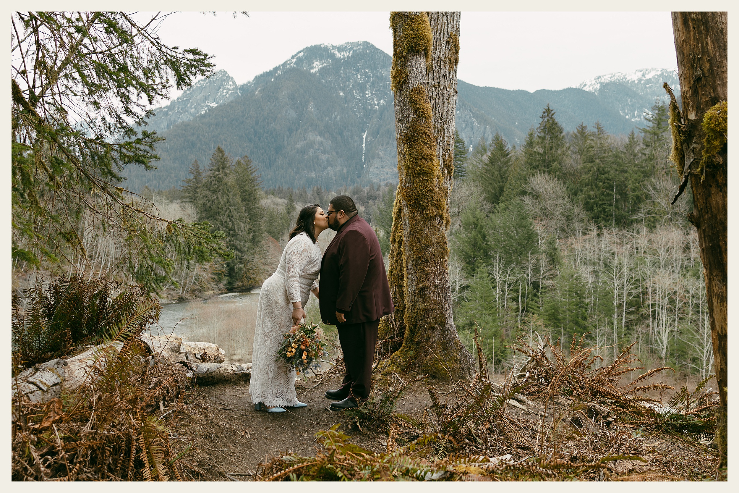bride and groom kissing in mountains