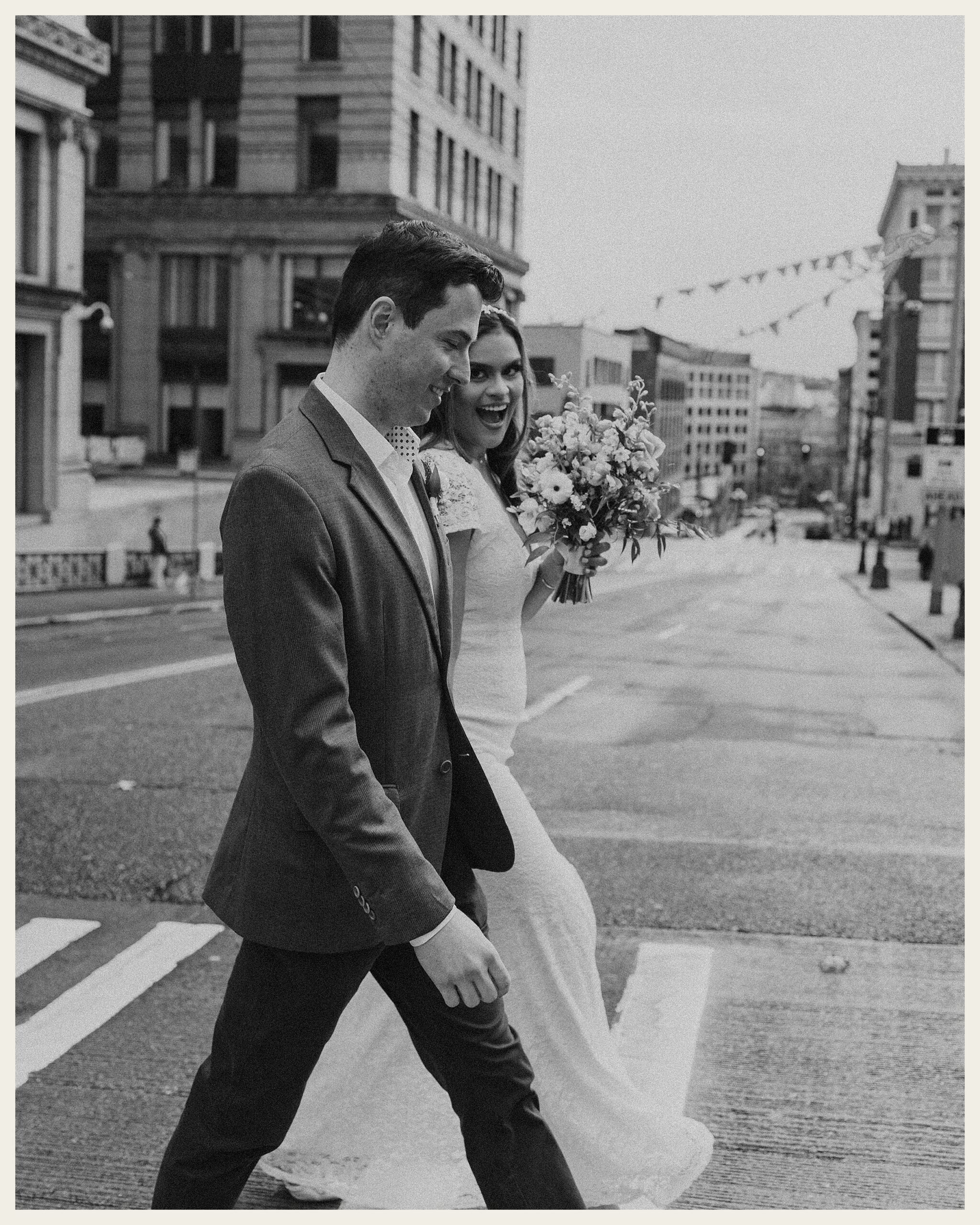 bride and groom walking in city