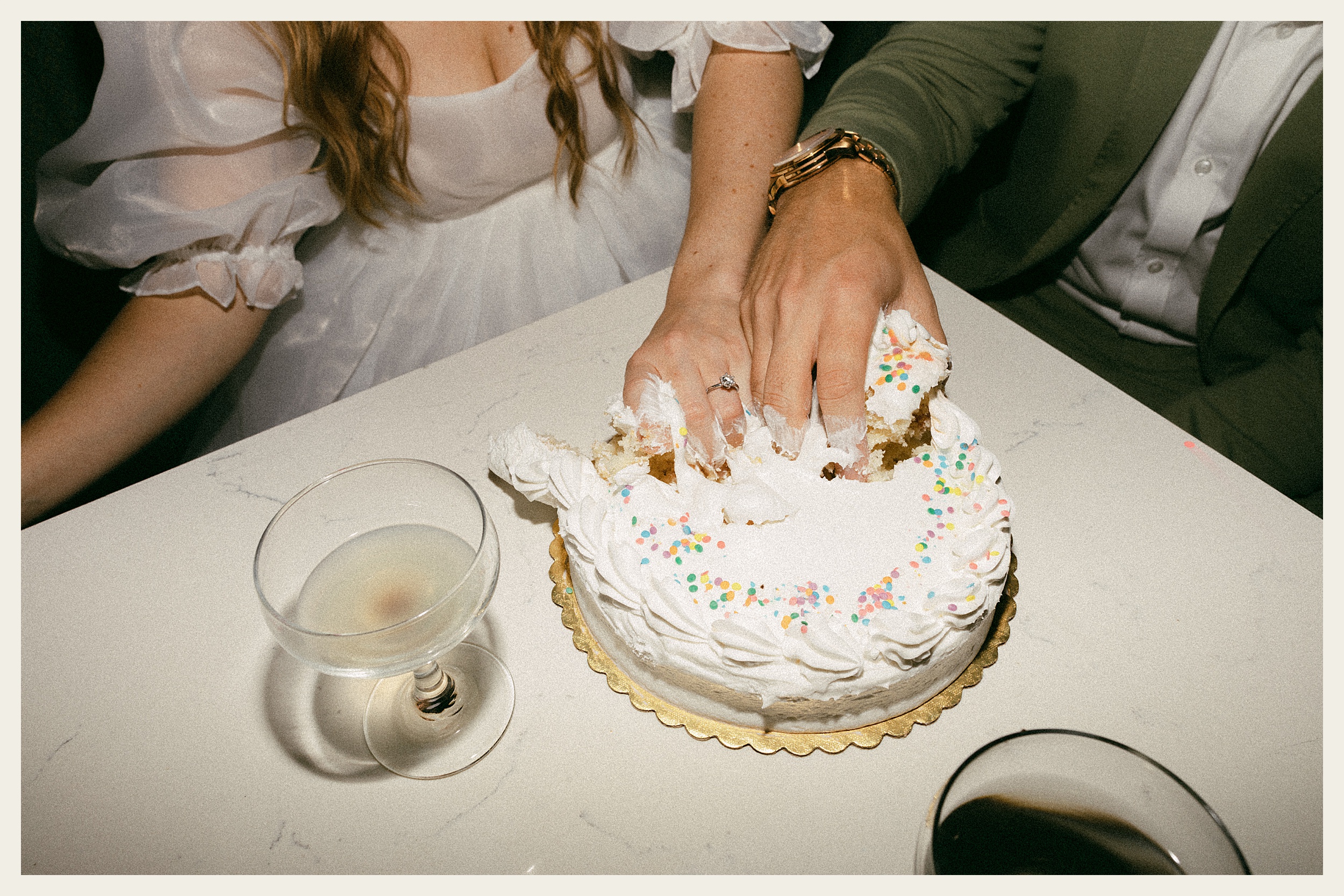 bride and groom grabbing cake