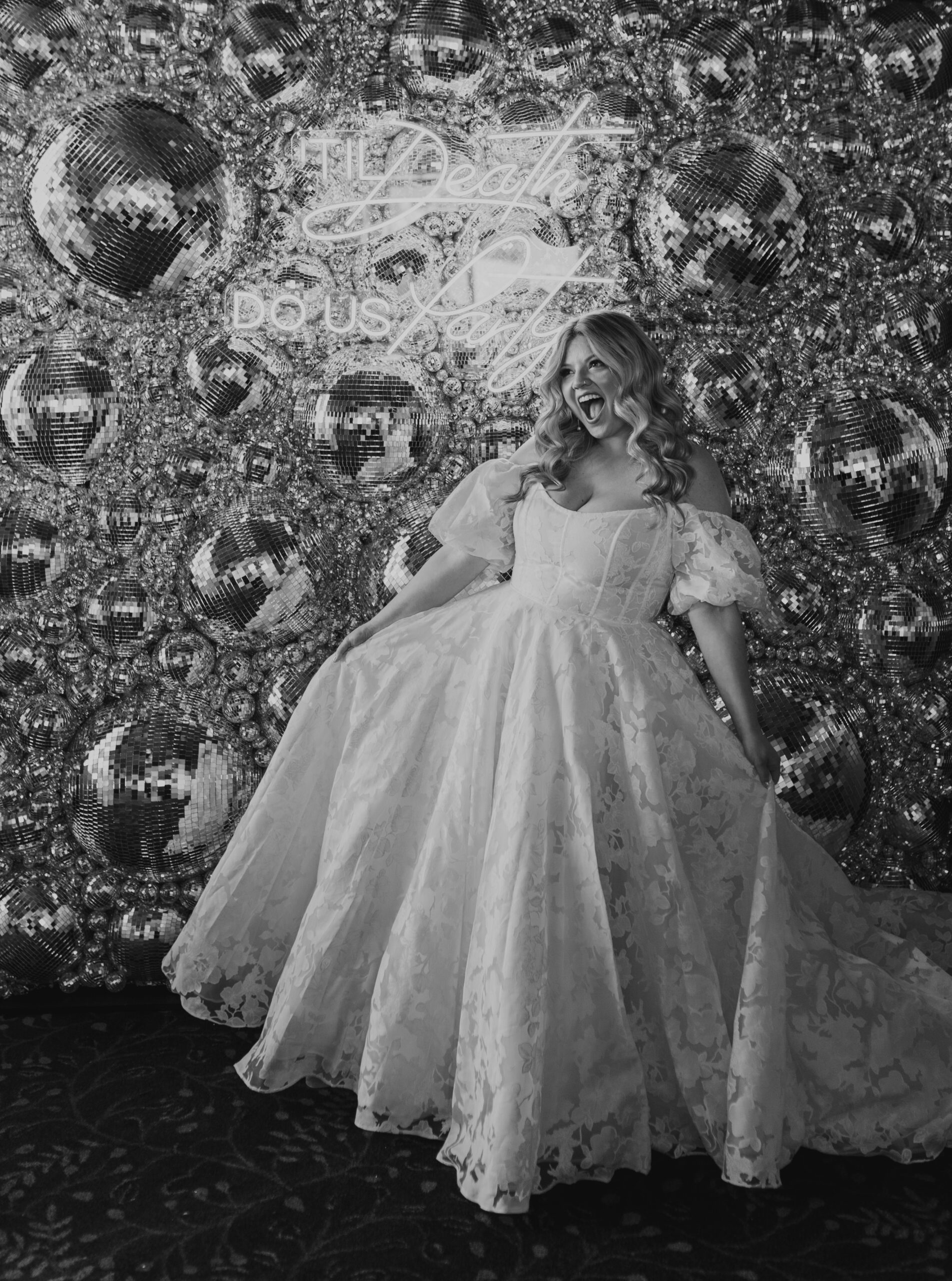 bride in front of disco ball wall